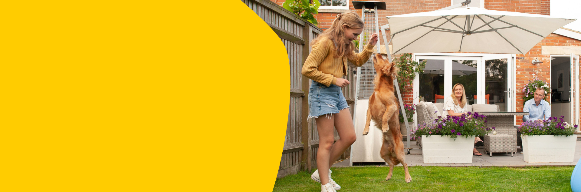 Tilly (who has CF) age 15 playing with her dog in the garden while her parents watch