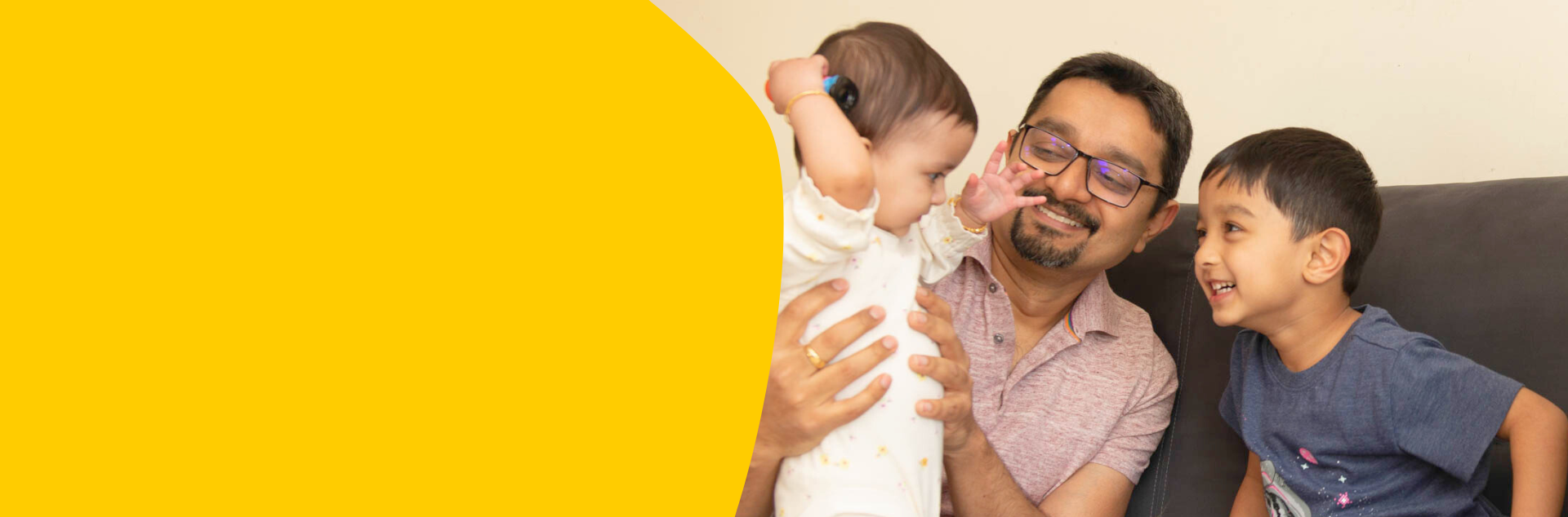 Dhyuti, 8 months, with her dad and brother