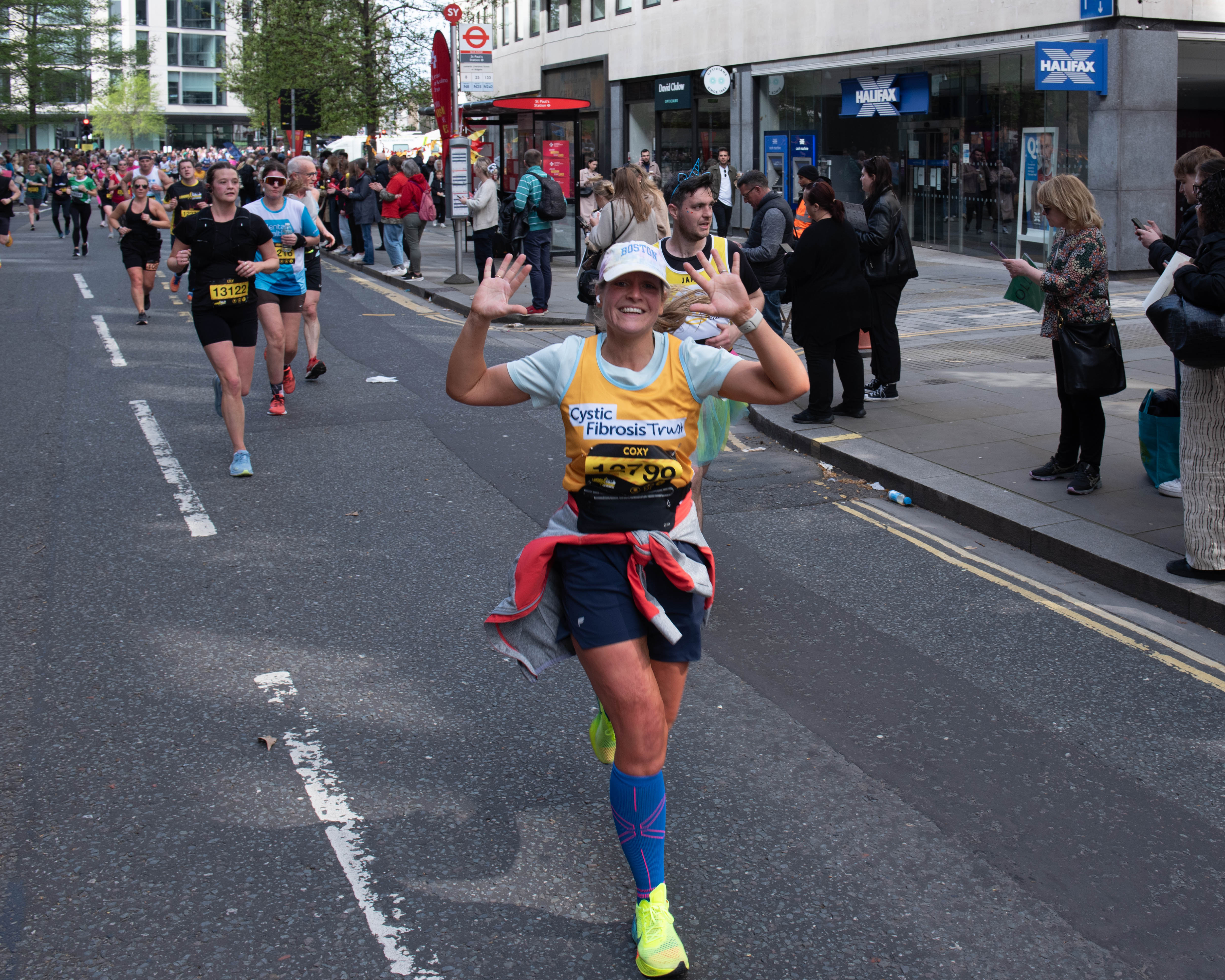 A lady running with Cystic Fibrosis Trust top on 