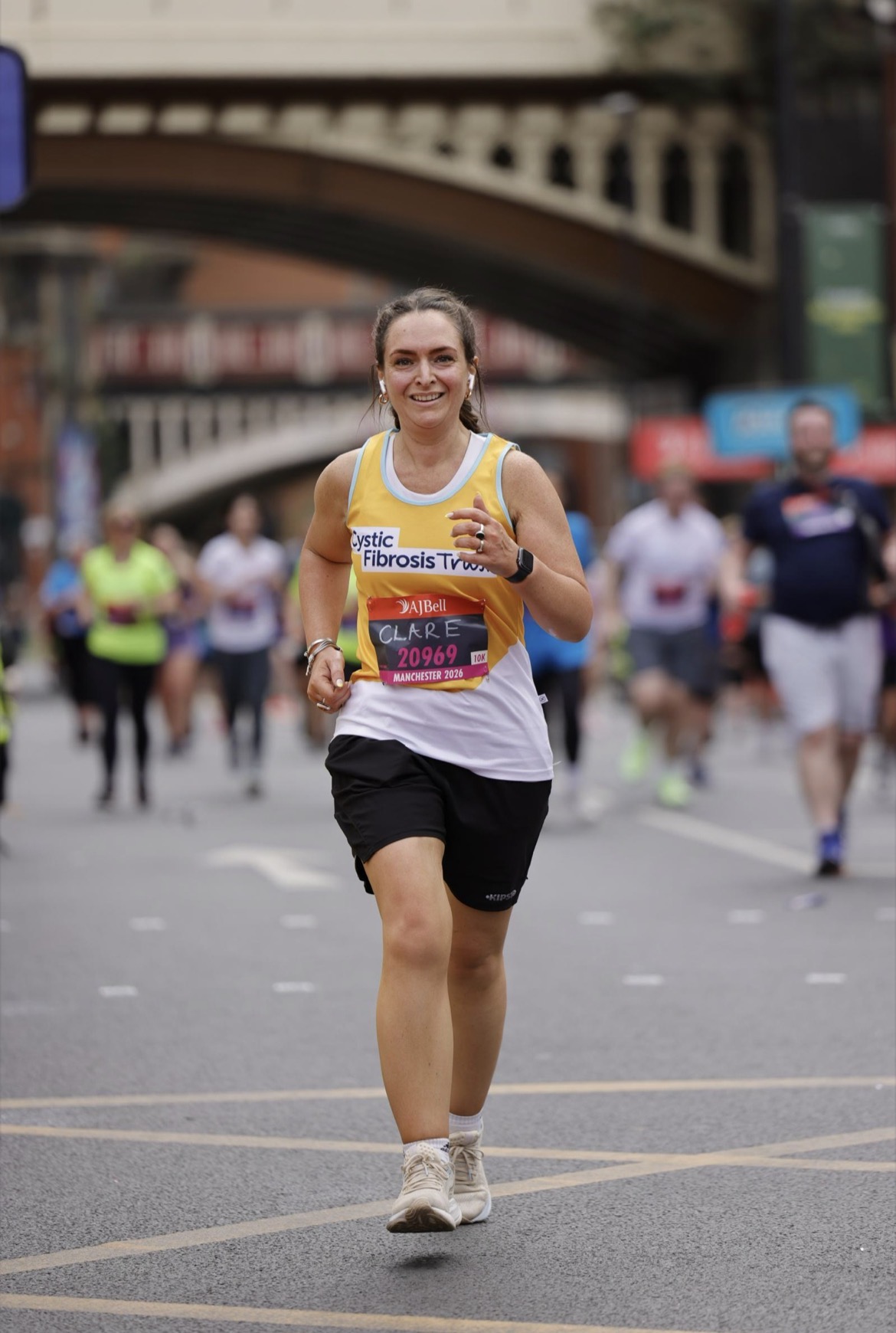 A lady running with Cystic Fibrosis Trust top on 