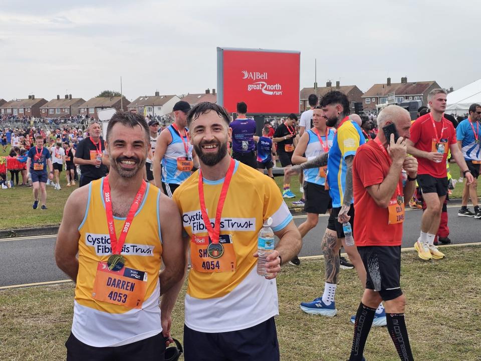 Darren stands at finish line