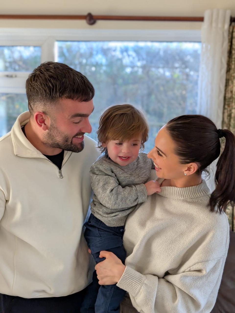 Navy smiling with his parents 