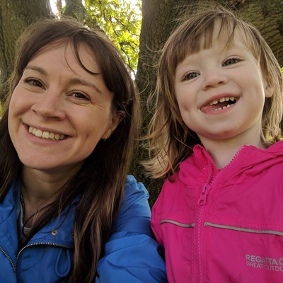 Woman and little girl smile at camera