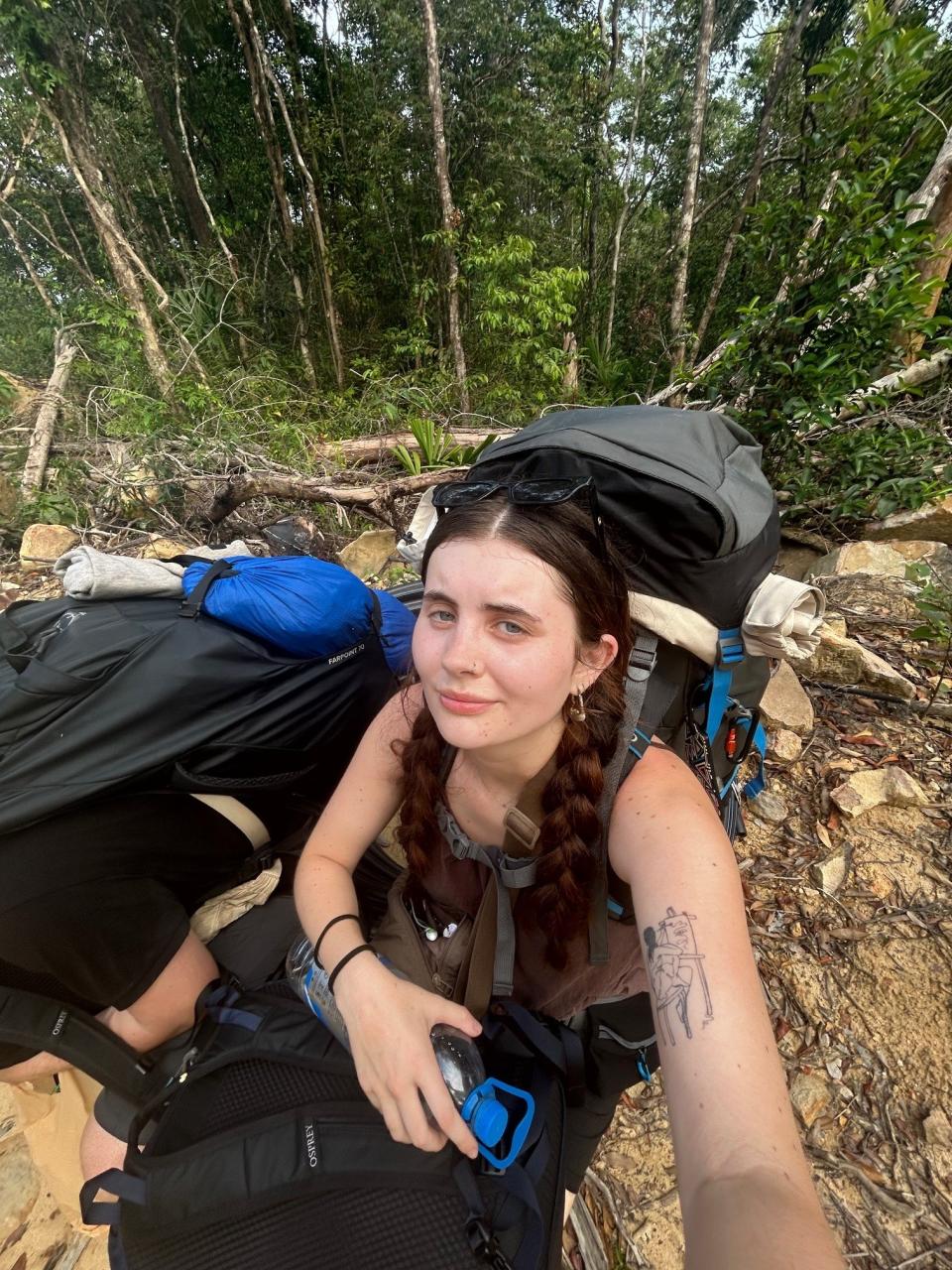 Me struggling with my 20kg backpack and taking a break in 40° heat