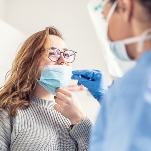 Healthcare worker delivering a COVID-19 test