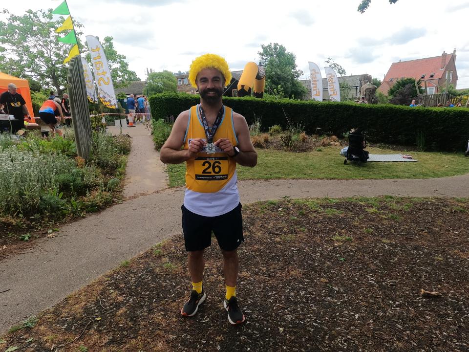 Darren stands with medal
