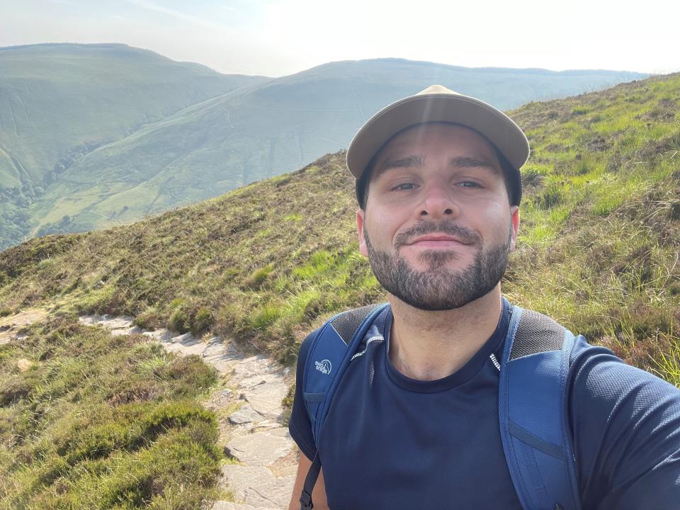 Kieran standing on a hill 