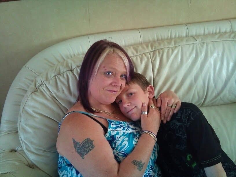 Jordan as a child with his mum, sat on the sofa