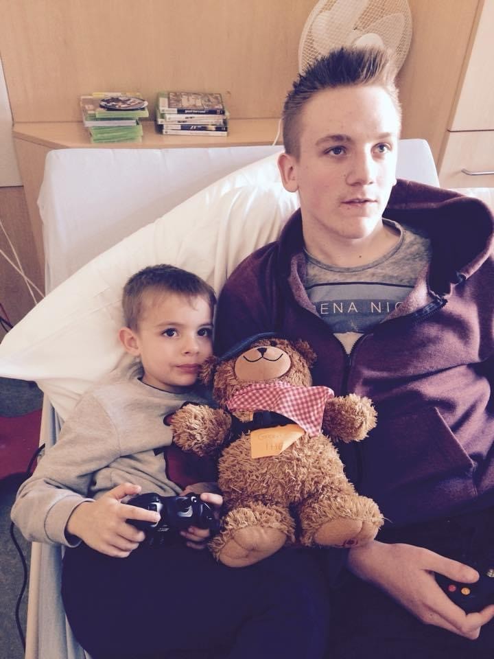 Jordan playing a PlayStation game with a nephew in hospital