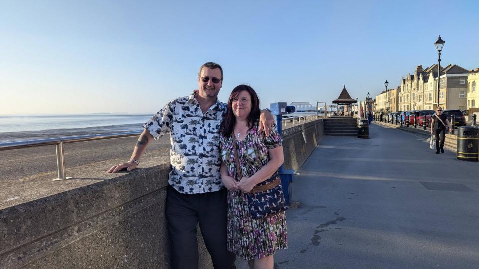 Morley has his arm around his partner on the seafront.