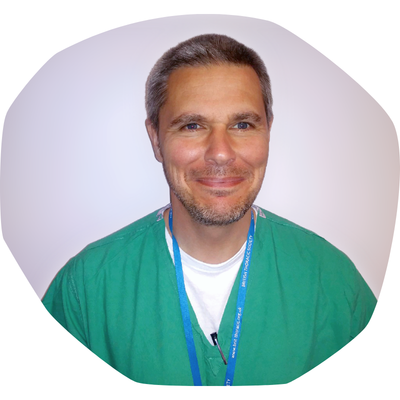 Dr Don Urquhart wearing scrubs