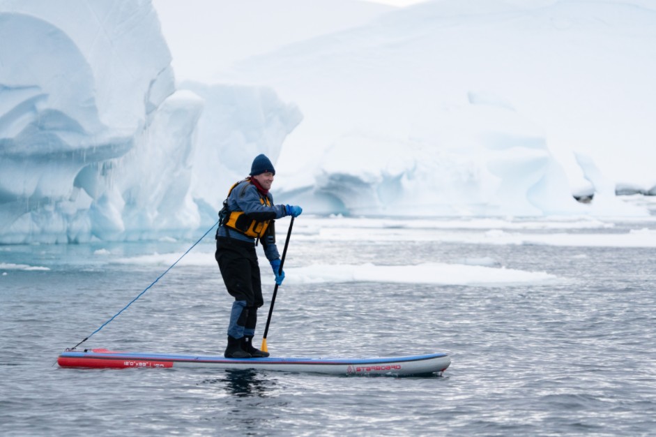 Josh paddleboarding in Antarctica