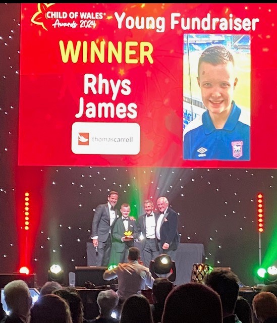 Rhys winning his award