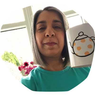 Sangeeta, Cystic Fibrosis Trust's Welfare and Rights Advisor, holding a Trust-branded mug