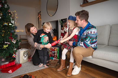 Family gathered around the Christmas tree
