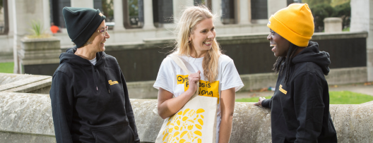 three women wearing Trust-branded products