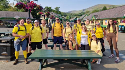 Large group of people dressed in yellow at the bottom of Snowdon mountain