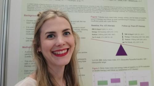 Photo of Laura by her poster