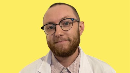 Photo of Ryan in lab coat