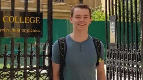 Photo of man outside by college gates