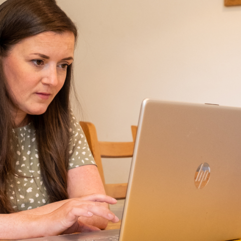 Woman reading laptop