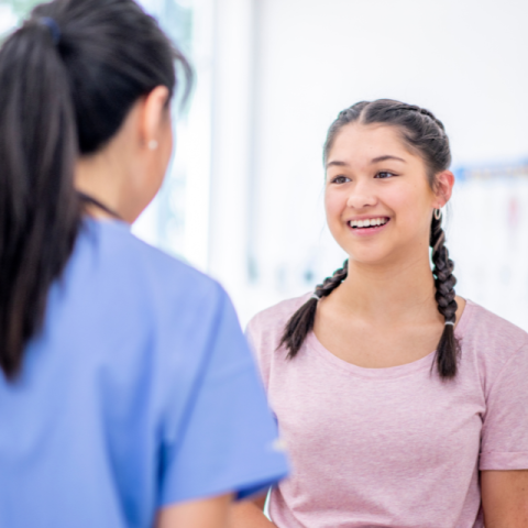 a teenage patient talks to a doctor
