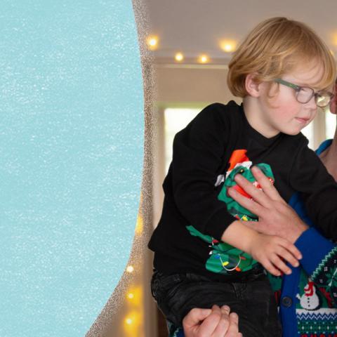 Little boy and dad looking at Christmas tree