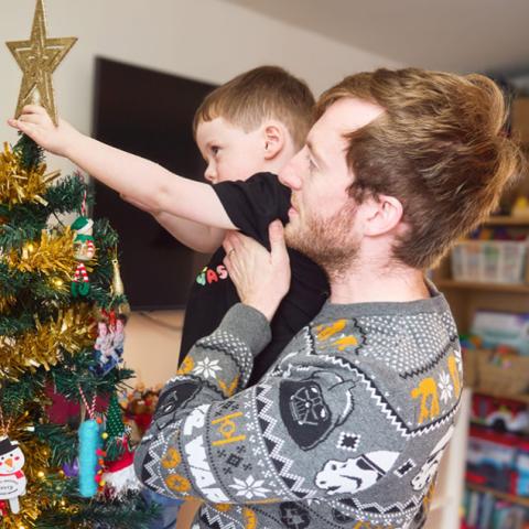 Father and son pictured with Christmas tree
