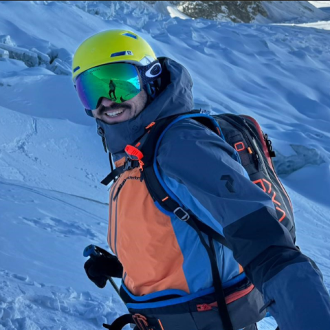 a man (Rich, who has CF) in ski gear on a snowy mountain