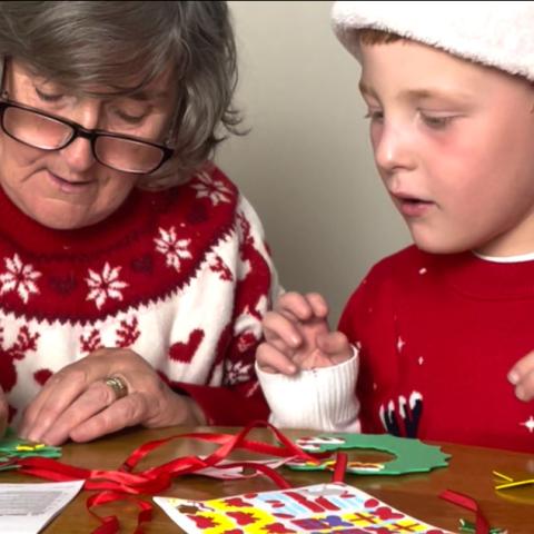 A woman and child doing Christmas crafting