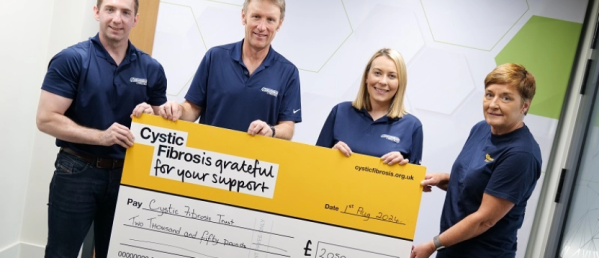 Cystic Fibrosis cheque being held up