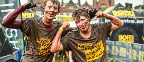 Two people after completing a Tough Mudder event