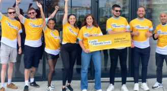 Group of people holding up cheque