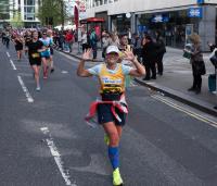 A lady running with Cystic Fibrosis Trust top on 