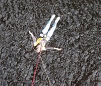 a lady in a yellow cystic fibrosis trust top doing a bungee jump
