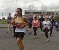 A lady running with Cystic Fibrosis Trust top on 