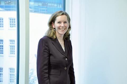 White woman with brown hair smiling at the camera