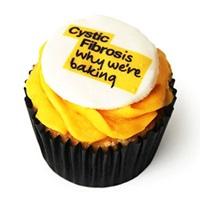 Cupcake with yellow icing with the words 'Cystic Fibrosis why we're baking' written on the top of it.