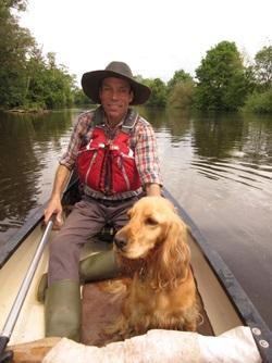 Andrew and his dog in a canoe