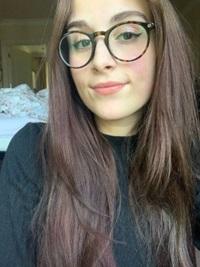 young woman with long brown hair and glasses