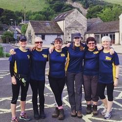 Six white women in walking gear. They are smiling at the camera.