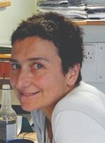 White woman with short hair smiling at camera