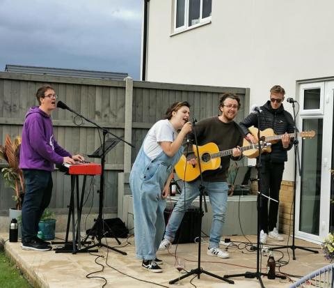 Band playing music in a back garden