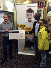 Timothy Cross awarding the Cystic Fibrosis Trust a donation for gene editing