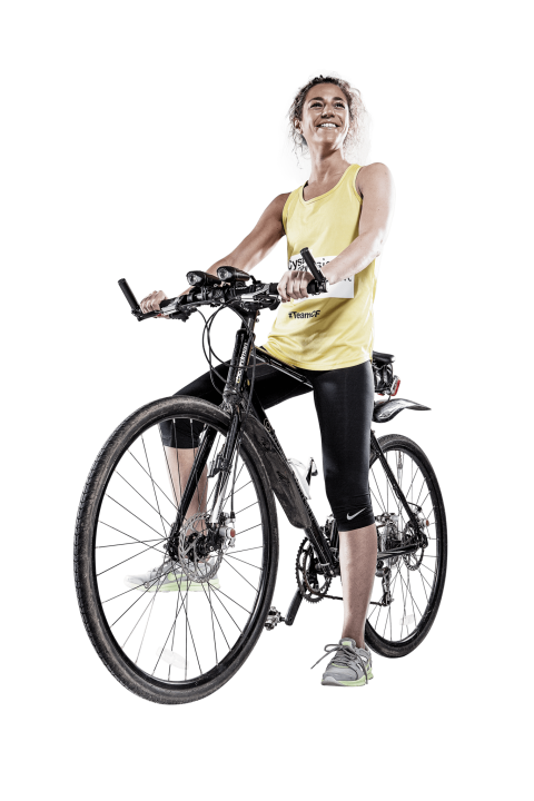 Woman riding bike wearing Cystic Fibrosis Trust cycling jersey