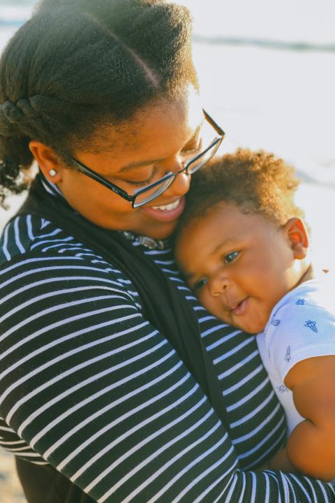 A woman cradling a baby