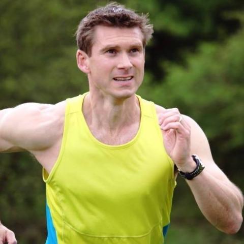 Fit-looking white man in yellow running vest