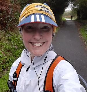 Happy selfie of a young white woman in hiking gear