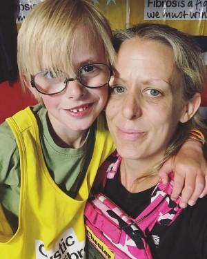 Woman and young son wearing running vests