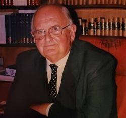 Older white man wearing dark suit